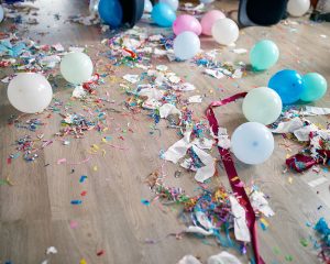 Top view of floor with after a party celebration with empty blue bottles Top view of floor with after a party celebration with empty blue bottles, wine glass and party decorations, messy living room interior, After party chaos, birthday